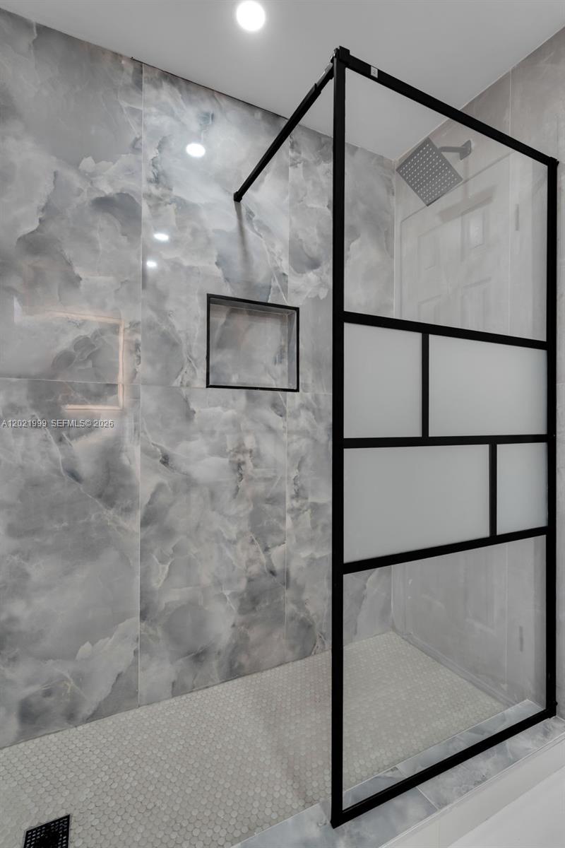 1660 West 26th Street Riviera Beach, FL 33404 - Photo 19 of 28 a bathroom with a shower and a mirror