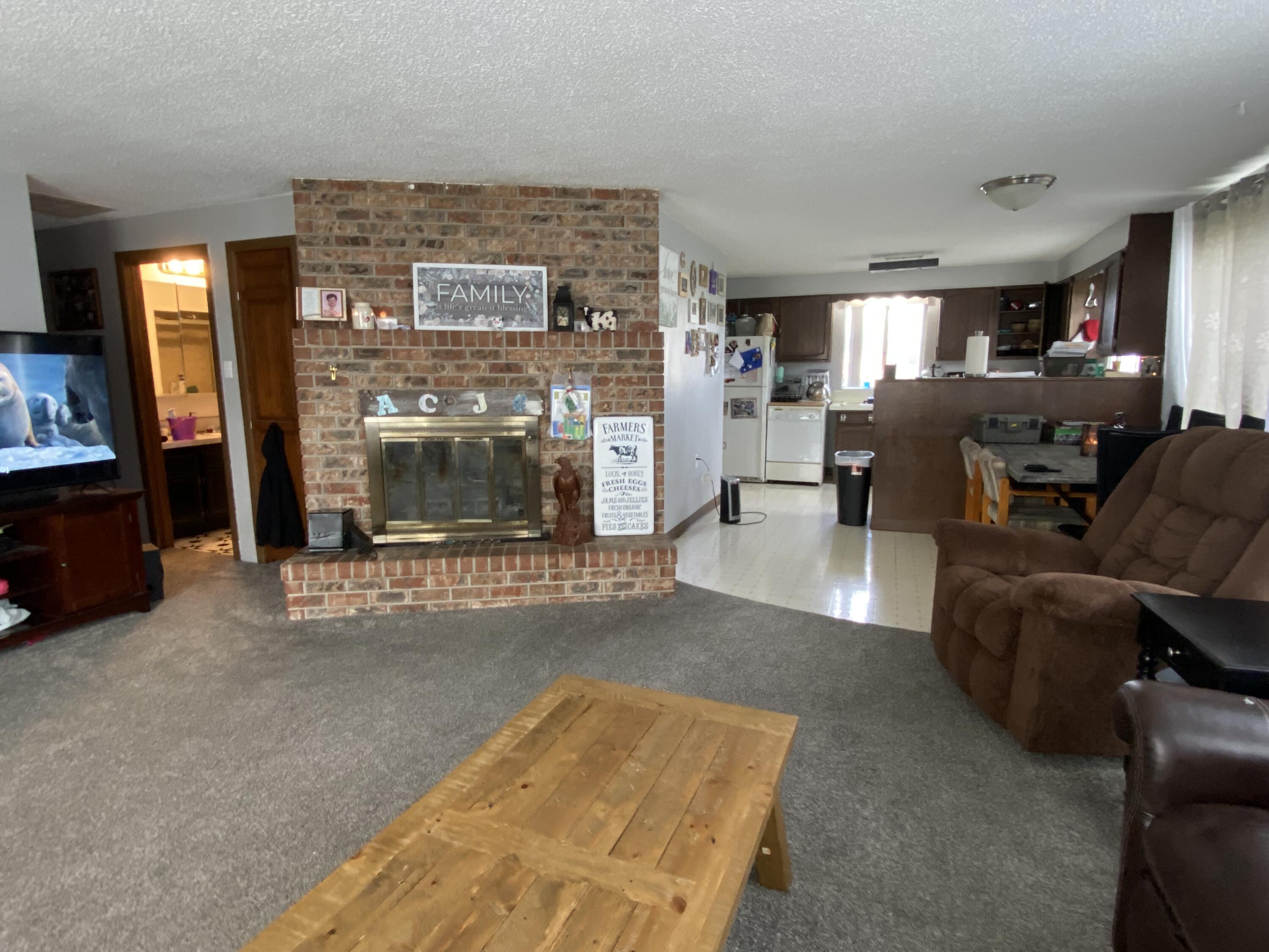 6735 South Prairie Road Tillamook, OR 97141 - Photo 11 of 23 a living room with furniture and a fireplace