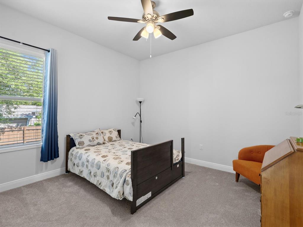 11981 Robina Road Weeki Wachee, FL 34614 - Photo 36 of 93 a bedroom with a bed and a chandelier fan