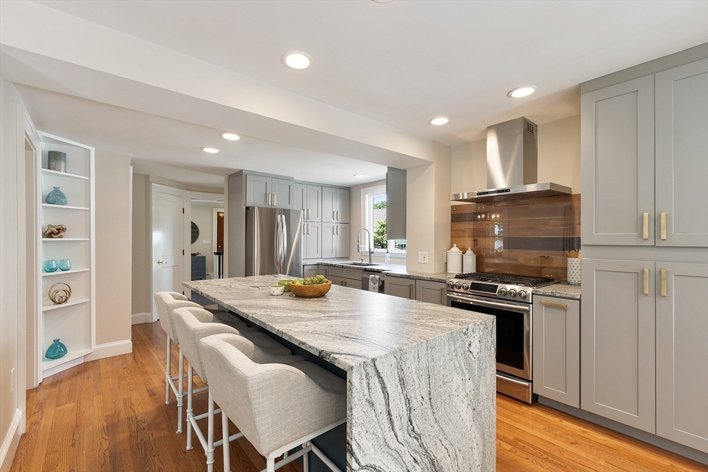 29 Downing Road Lexington, MA 02421 - Photo 15 of 38 a kitchen with a stove a refrigerator and a dining table