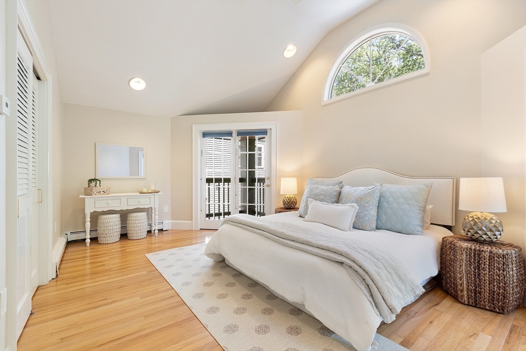 29 Downing Road Lexington, MA 02421 - Photo 29 of 38 a spacious bedroom with a bed a table and a large window