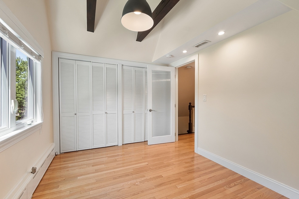 29 Downing Road Lexington, MA 02421 - Photo 33 of 38 a view of an empty room with wooden floor and a window