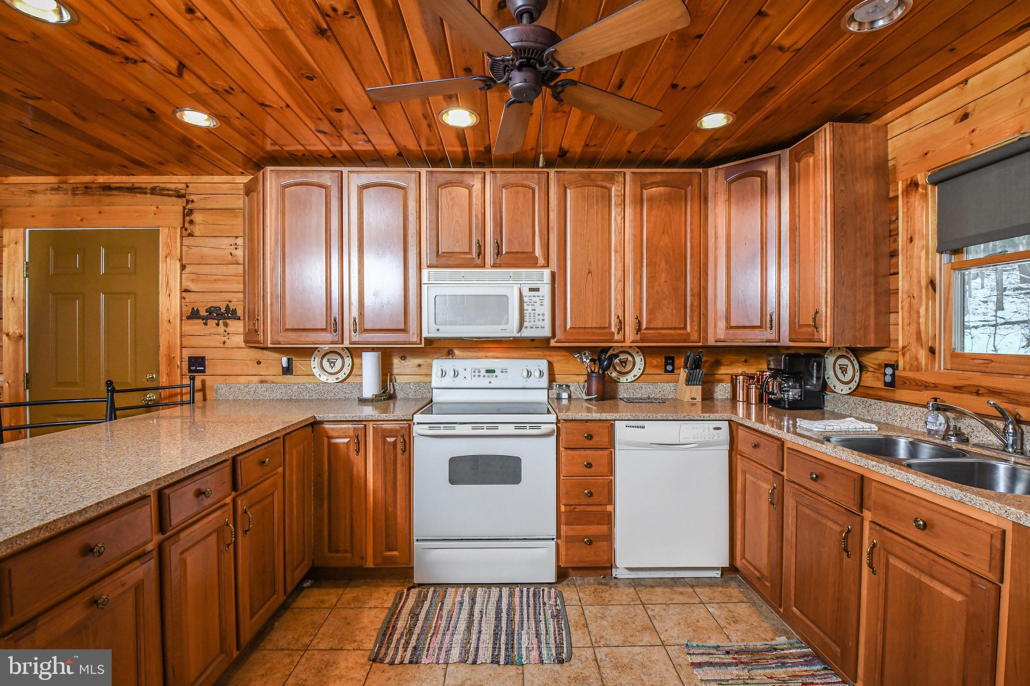 412 Tanglewood Road Oakland, MD 21550 - Photo 27 of 41 a kitchen with a sink stove and cabinets