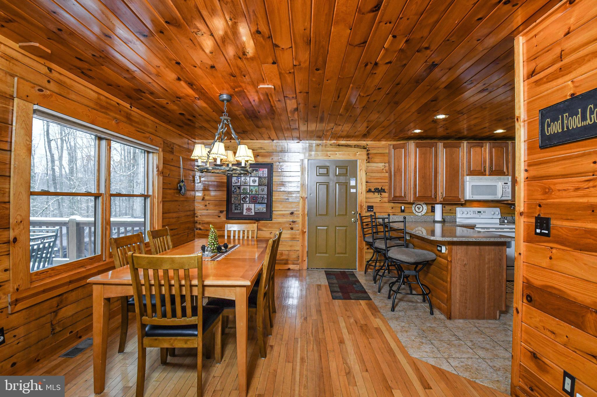 412 Tanglewood Road Oakland, MD 21550 - Photo 9 of 41 a view of a dining room with furniture window and wooden floor