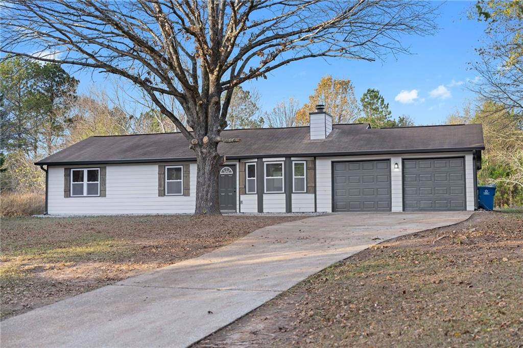 313 Oak Ridge Auburn, GA 30011 - Photo 1 of 1 a front view of a house with a garden