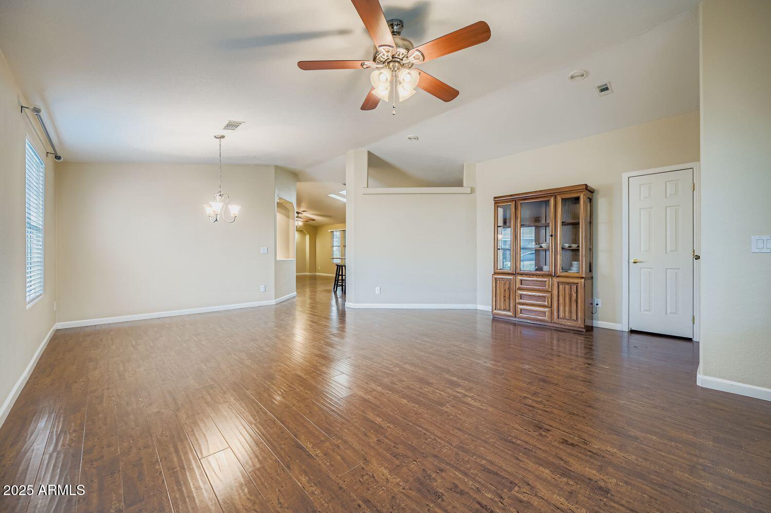 2550 South Ellsworth Road, Unit 277 Mesa, AZ 85209 - Photo 5 of 20 a view of empty room with wooden floor and fan
