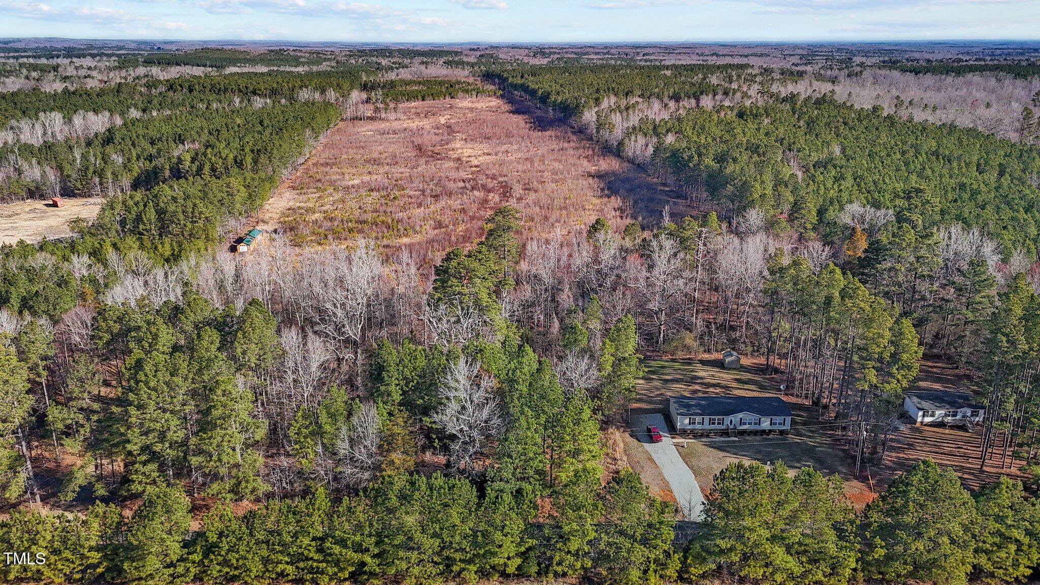 an aerial view of a houses with a yard