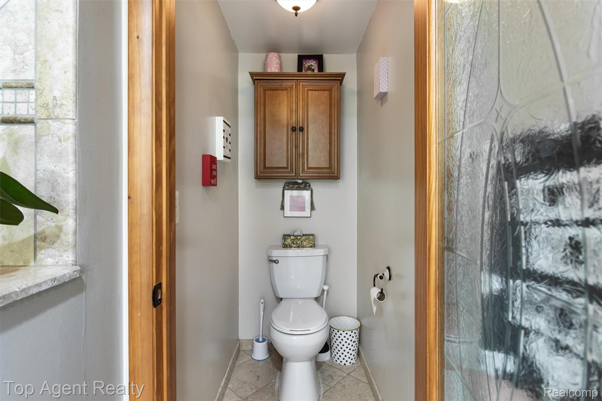 32341 Woody Road Fraser, MI 48026 - Photo 24 of 47 Powder room featuring a light-colored toilet, a wood-finish cabinet with double doors, and a ceiling-mounted light fixture
