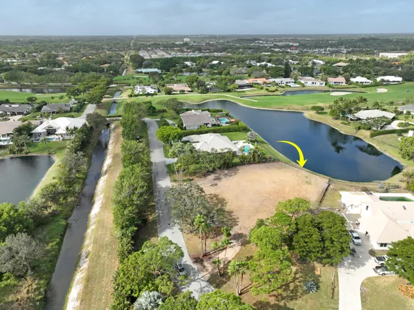 an aerial view of residential houses with outdoor space and lake view