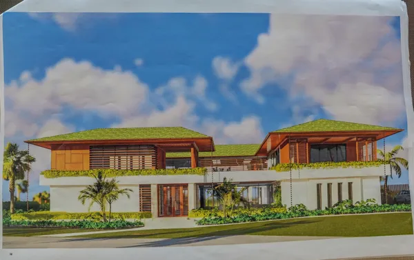 a front view of a house with a garden and plants