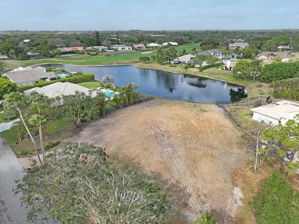 a view of a lake with houses in the back
