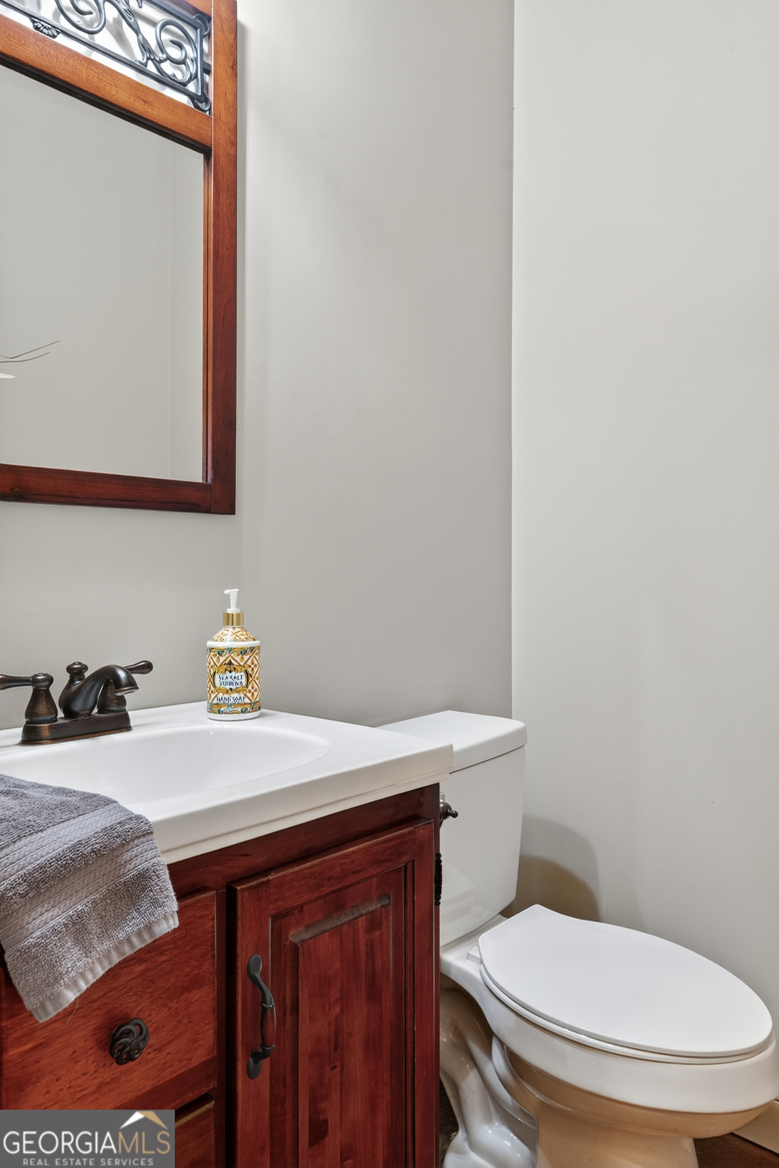 1583 Hickory Flat Road Gillsville, GA 30543 - Photo 36 of 78 a bathroom with a sink a toilet and mirror