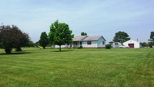 a view of house with a garden