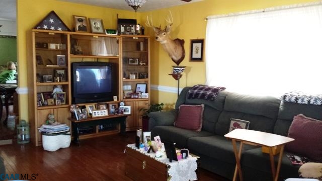 9079 South James River Road Buckingham, VA 23921 - Photo 12 of 16 a living room with furniture a flat screen tv and a fireplace