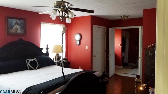 9079 South James River Road Buckingham, VA 23921 - Photo 5 of 16 a bedroom with a bed and a chandelier