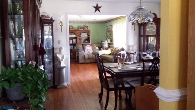 9079 South James River Road Buckingham, VA 23921 - Photo 9 of 16 a view of a dining room with furniture and chandelier