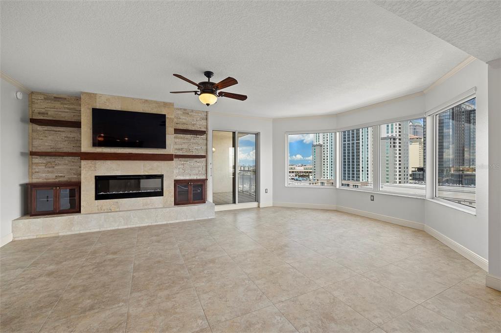 371 Channelside Walk Way, Unit 902 Tampa, FL 33602 - Photo 21 of 50 a view of an empty room with a flat screen tv and a fireplace