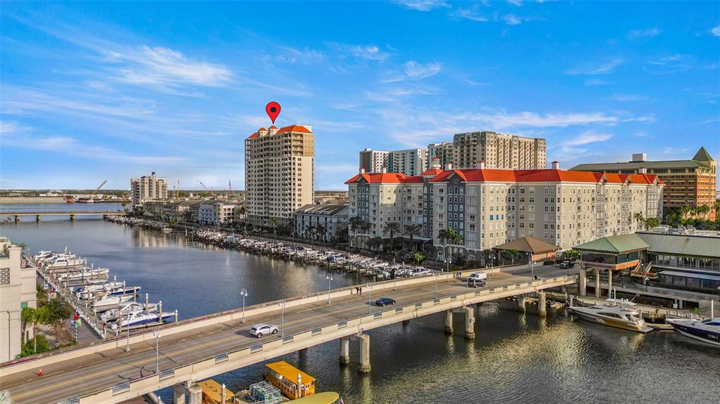 371 Channelside Walk Way, Unit 902 Tampa, FL 33602 - Photo 6 of 50 a group of people sitting on a pier next to a lake
