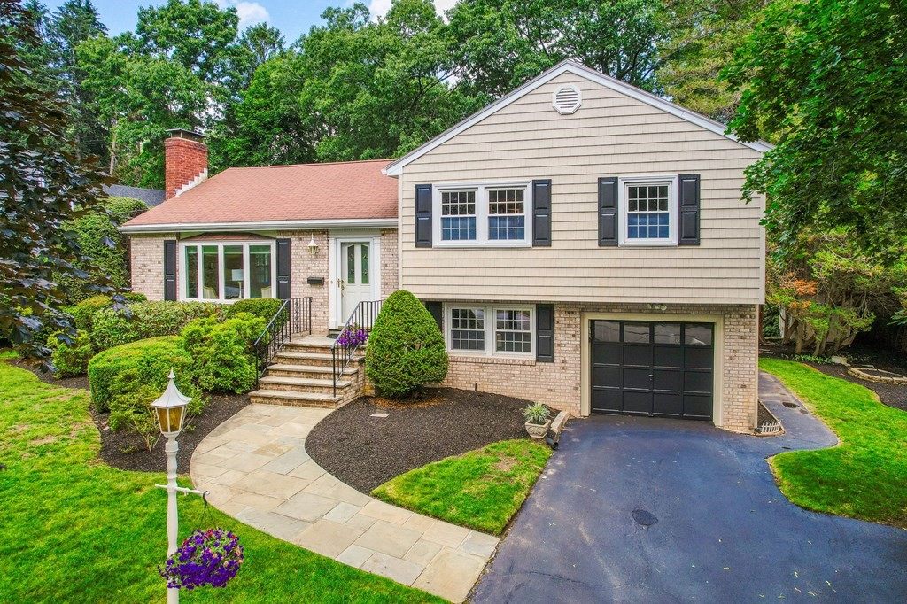 28 Wingate Road Waltham, MA 02451 - Photo 1 of 31 a front view of a house with a yard and garage