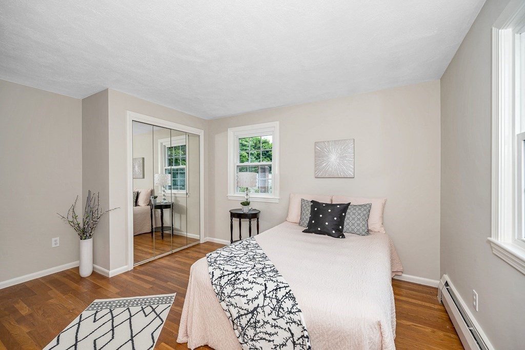 28 Wingate Road Waltham, MA 02451 - Photo 16 of 31 a bedroom with a bed and wooden floor