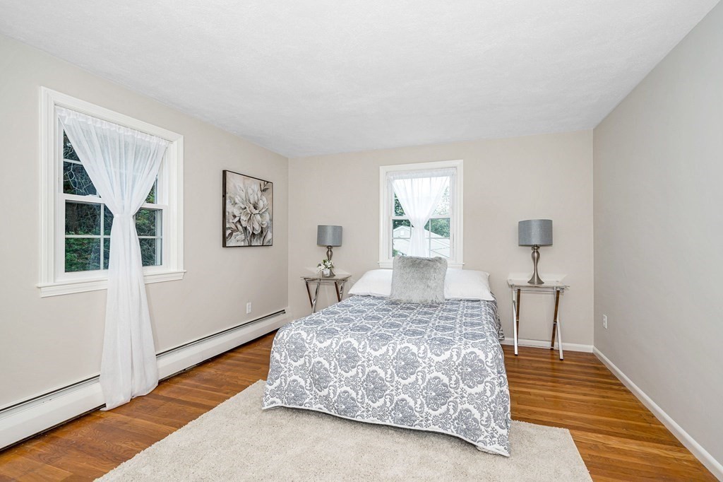 28 Wingate Road Waltham, MA 02451 - Photo 17 of 31 a bedroom with a bed and wooden floor