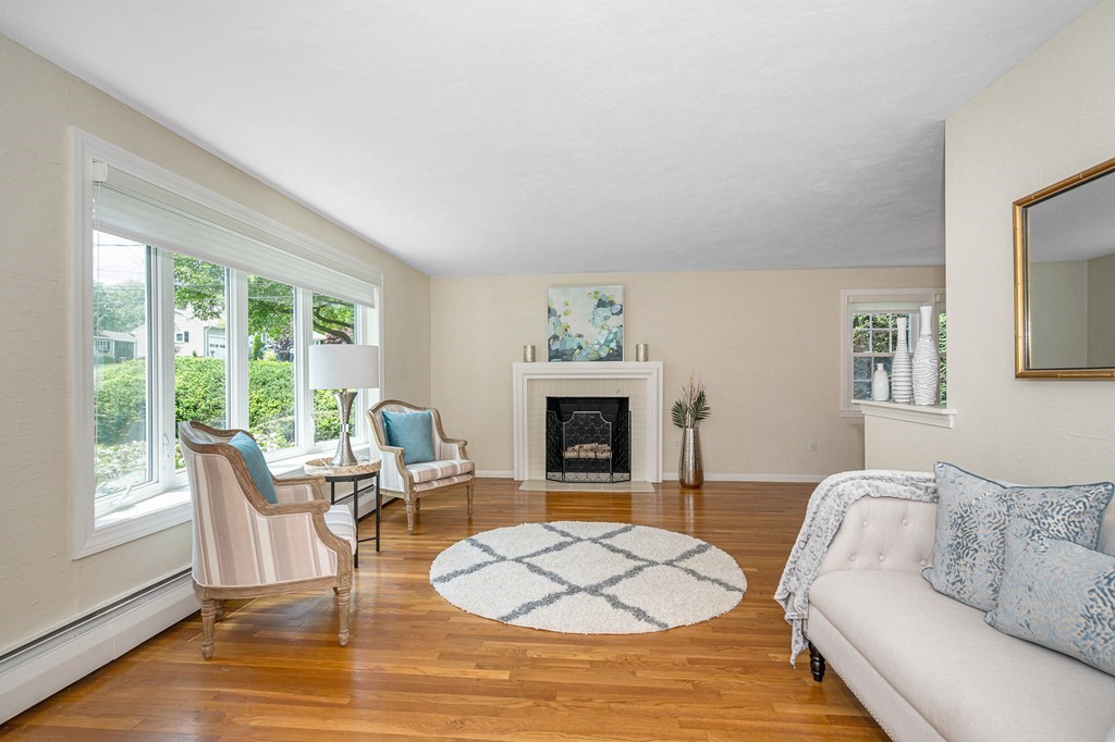 28 Wingate Road Waltham, MA 02451 - Photo 3 of 31 a living room with furniture a fireplace and a large window