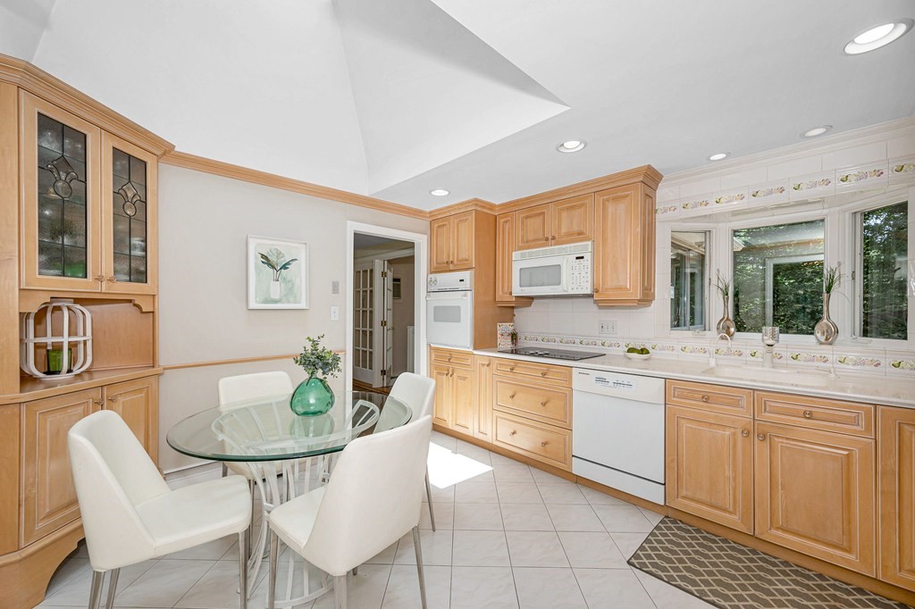 28 Wingate Road Waltham, MA 02451 - Photo 8 of 31 a kitchen with granite countertop sink table and chairs