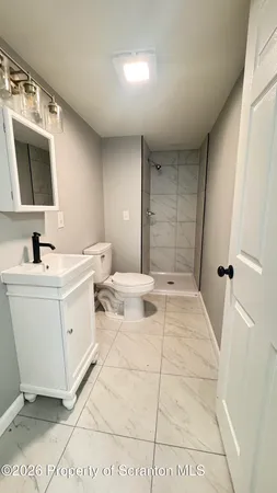 a bathroom with a sink toilet and mirror