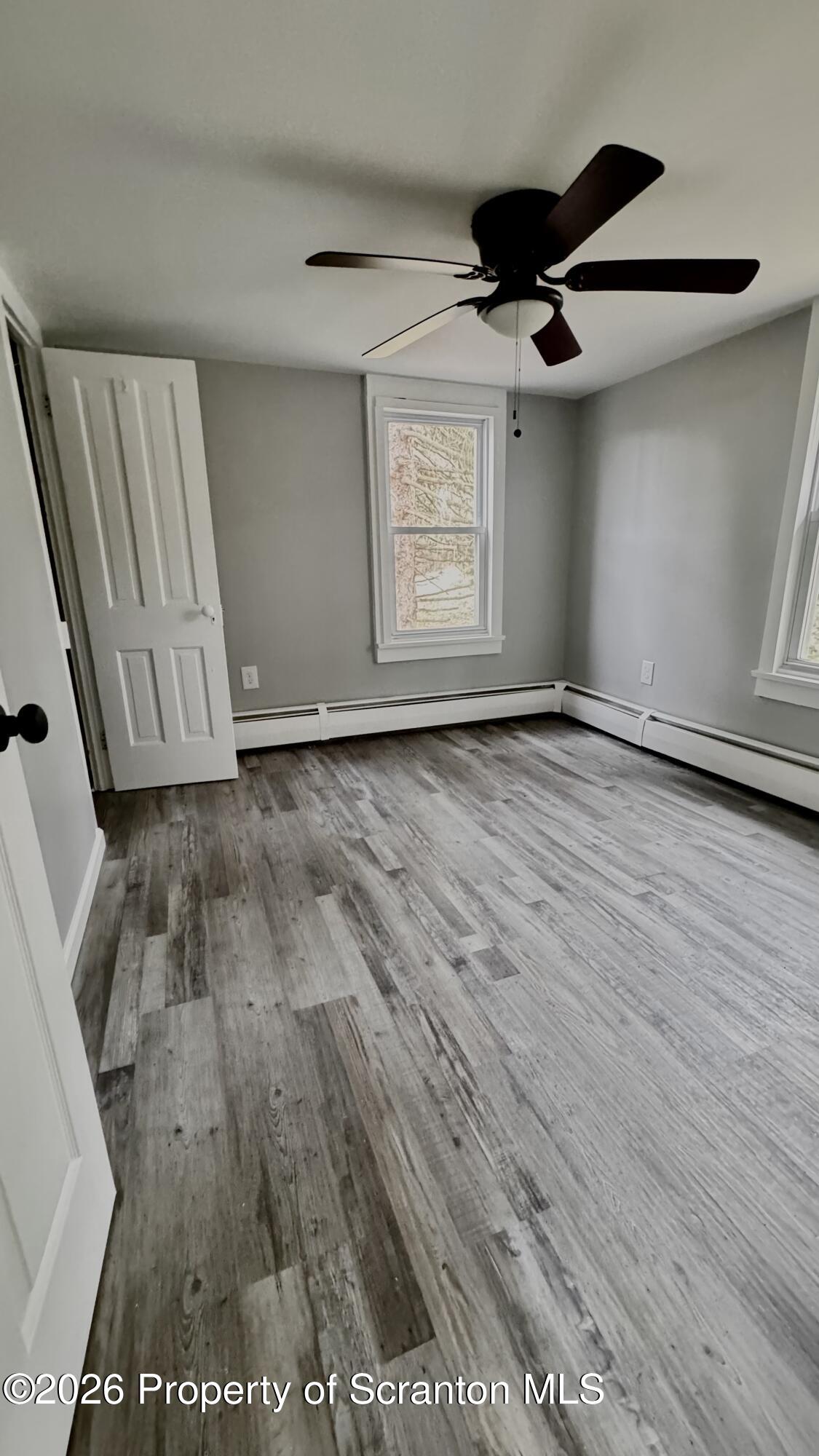 23-25 Shannon Street Simpson, PA 18407 - Photo 13 of 17 an empty room with wooden floor cabinet and windows