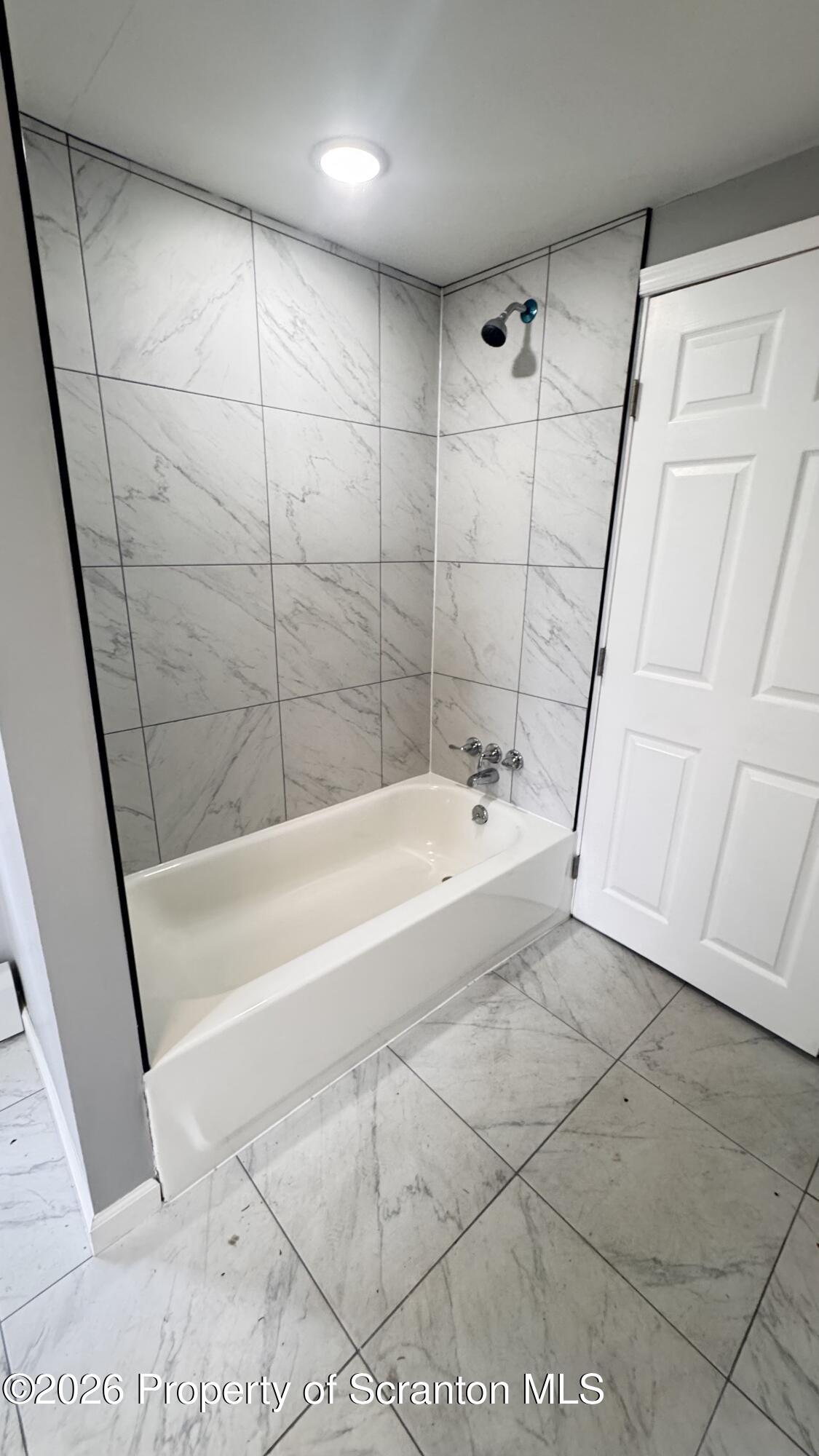 23-25 Shannon Street Simpson, PA 18407 - Photo 6 of 17 a spacious bathroom with a bathtub and a shower