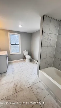 a spacious bathroom with a tub and shower