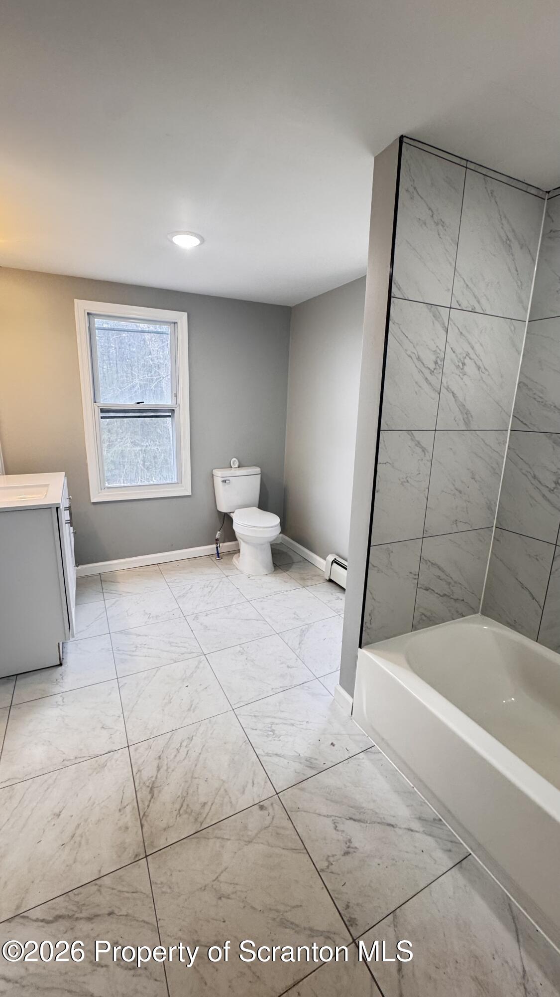 23-25 Shannon Street Simpson, PA 18407 - Photo 7 of 17 a spacious bathroom with a tub and shower