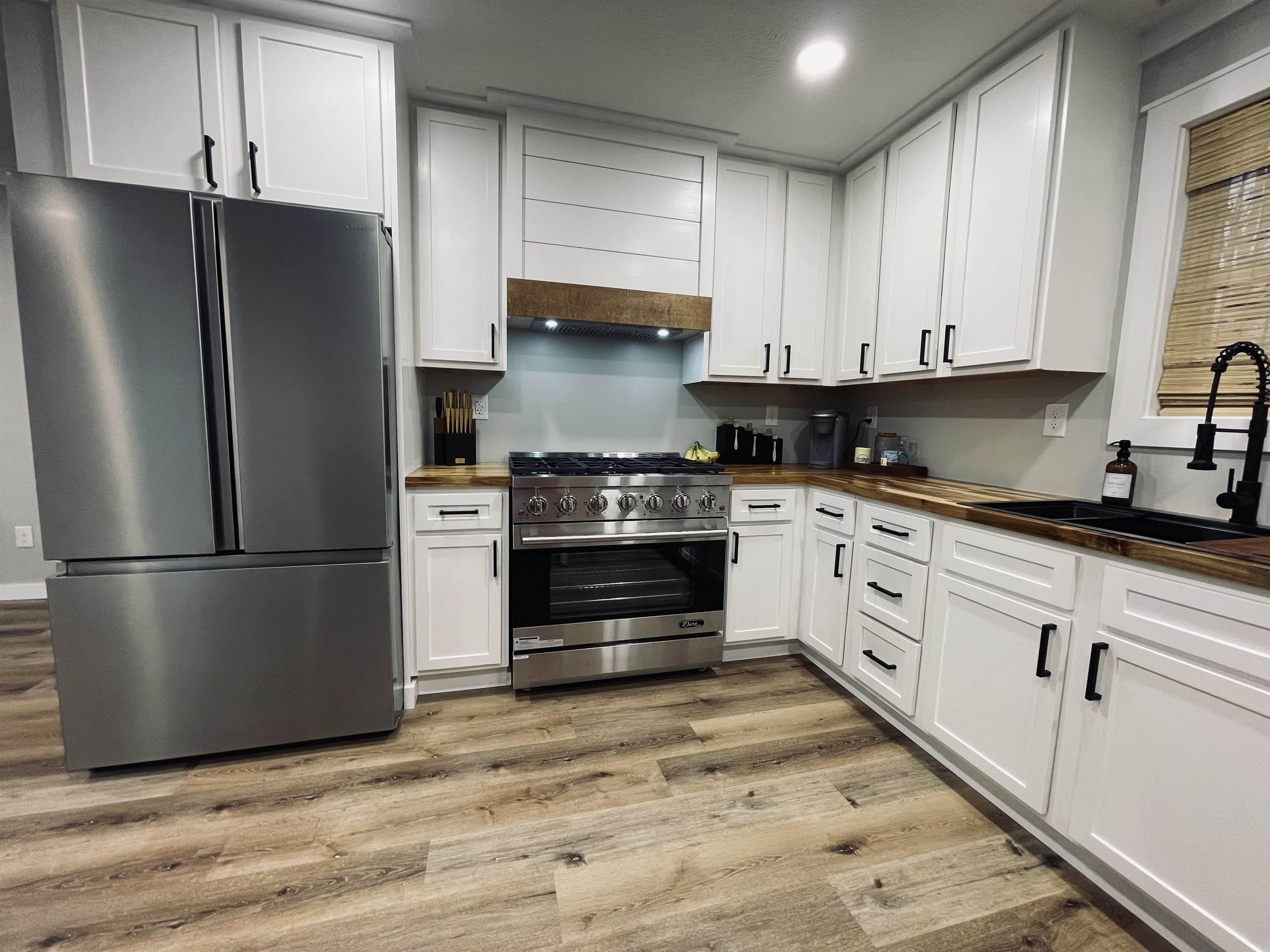 135 West 3rd Street Henderson, TN 38340 - Photo 11 of 31 Kitchen with stainless steel appliances, wood counters, white cabinets, light wood finished floors, and recessed lighting