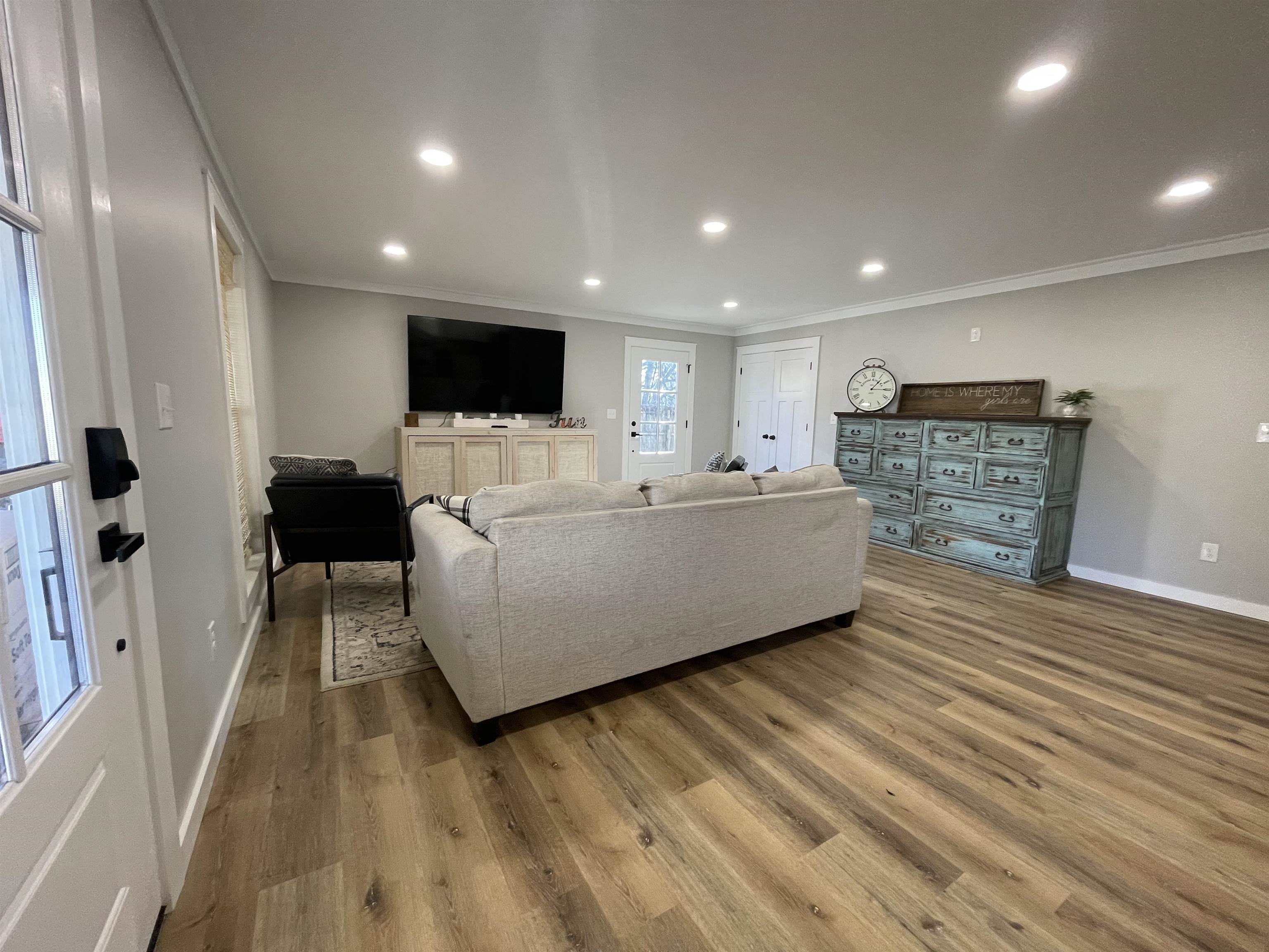 135 West 3rd Street Henderson, TN 38340 - Photo 13 of 31 Living room featuring wood finished floors, ornamental molding, and recessed lighting