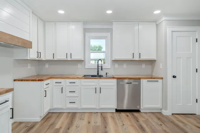a kitchen with stainless steel appliances granite countertop a sink and cabinets