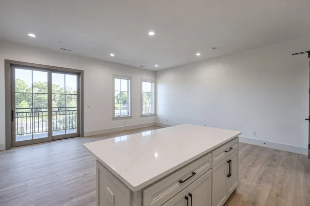 a room with a wooden floor and window