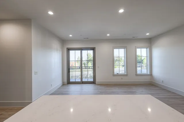 an empty room with windows and entrance