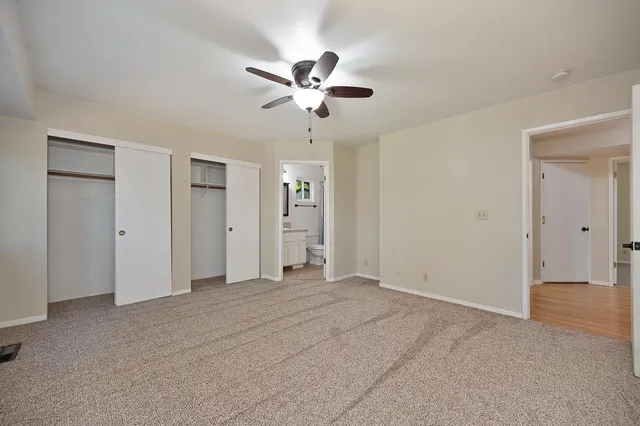 a view of empty room with a ceiling fan