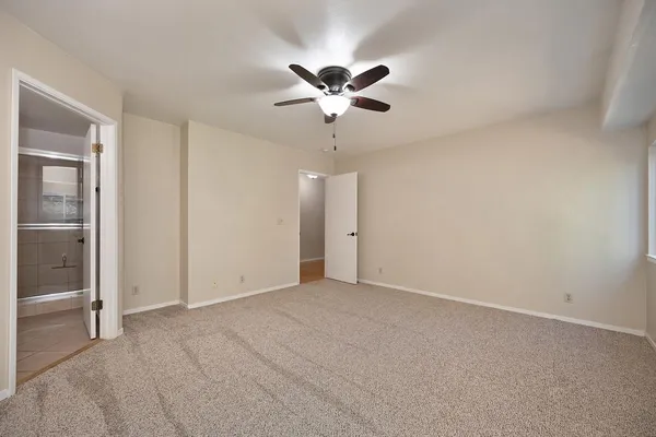 a view of a livingroom with a ceiling fan and window
