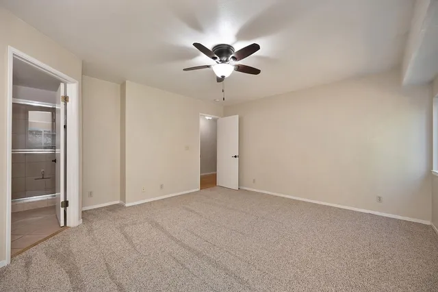 a view of a livingroom with a ceiling fan and window