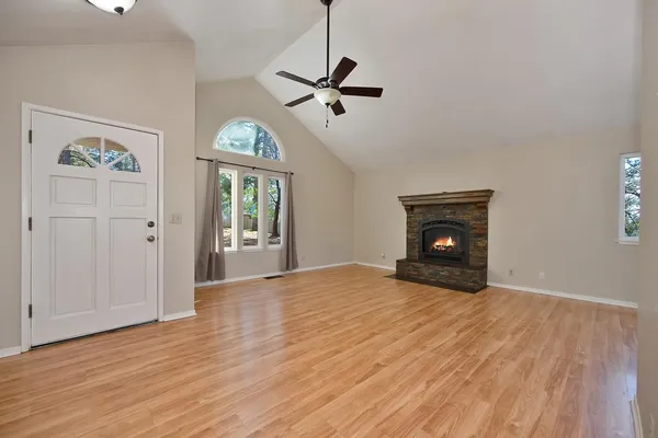 a view of empty room with wooden floor
