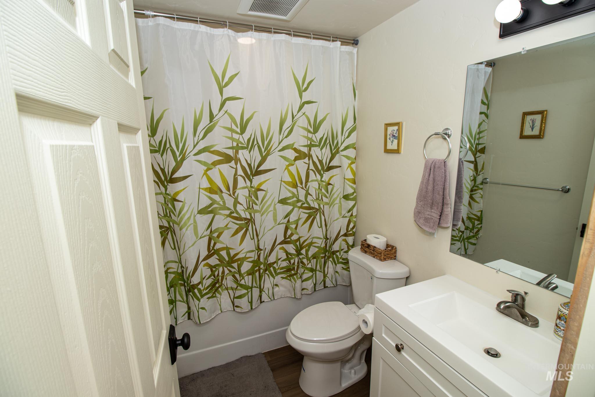 263 Glory Lane Orofino, ID 83544 - Photo 33 of 48 Bathroom with vanity, shower / bath combo with shower curtain, and dark wood-style floors