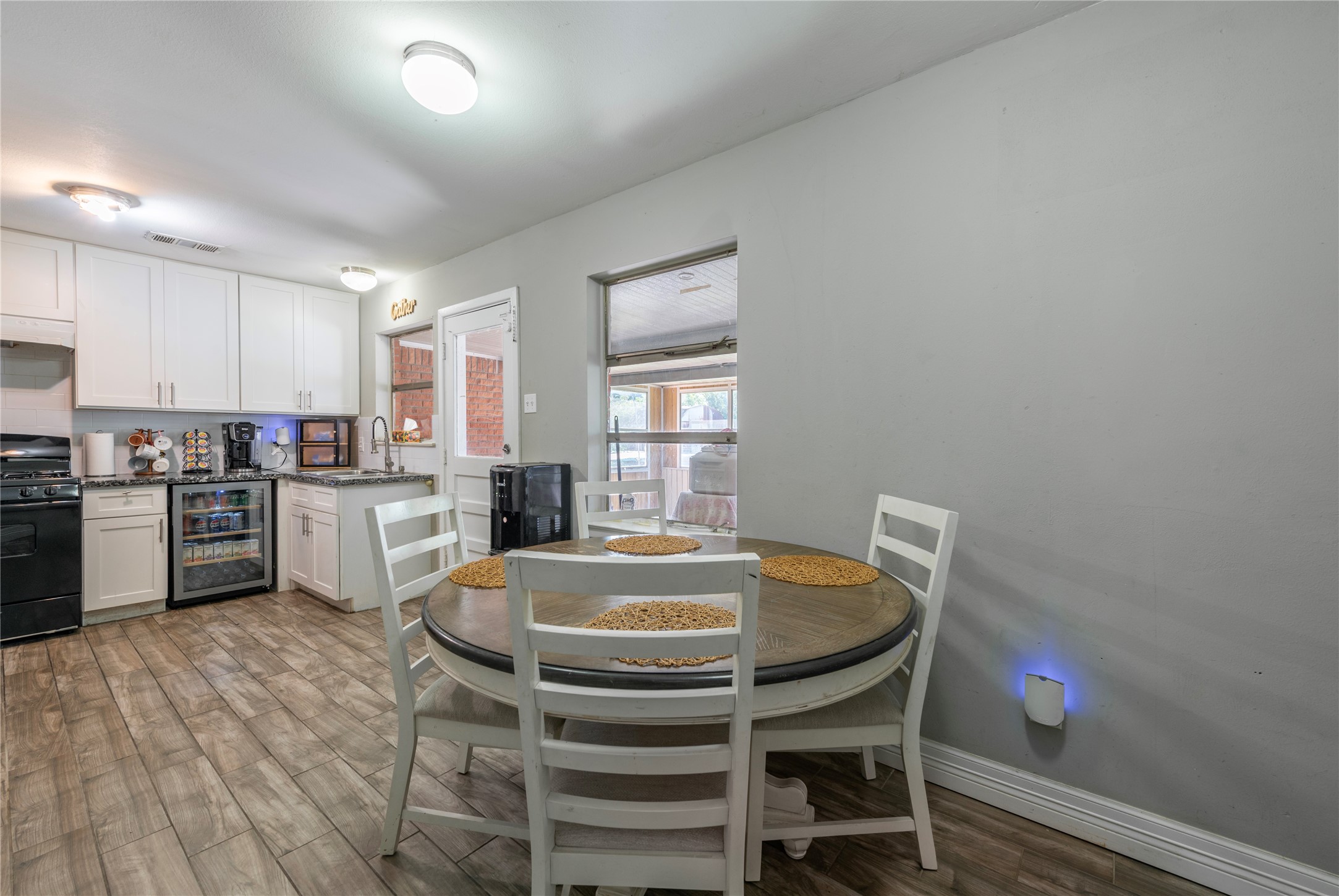 10526 Tolman Street Houston, TX 77034 - Photo 11 of 22 a kitchen with a table chairs refrigerator and cabinets