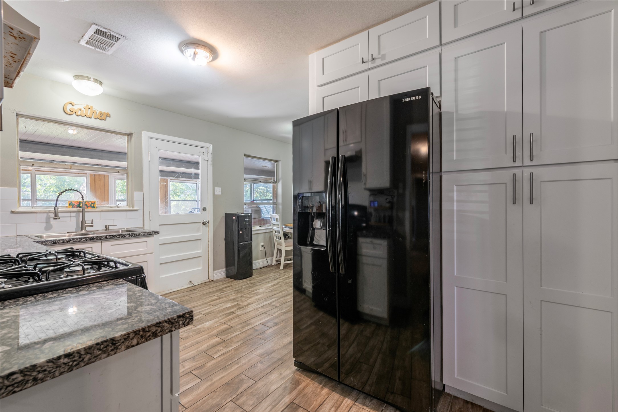 10526 Tolman Street Houston, TX 77034 - Photo 6 of 22 a kitchen with a refrigerator and a stove top oven