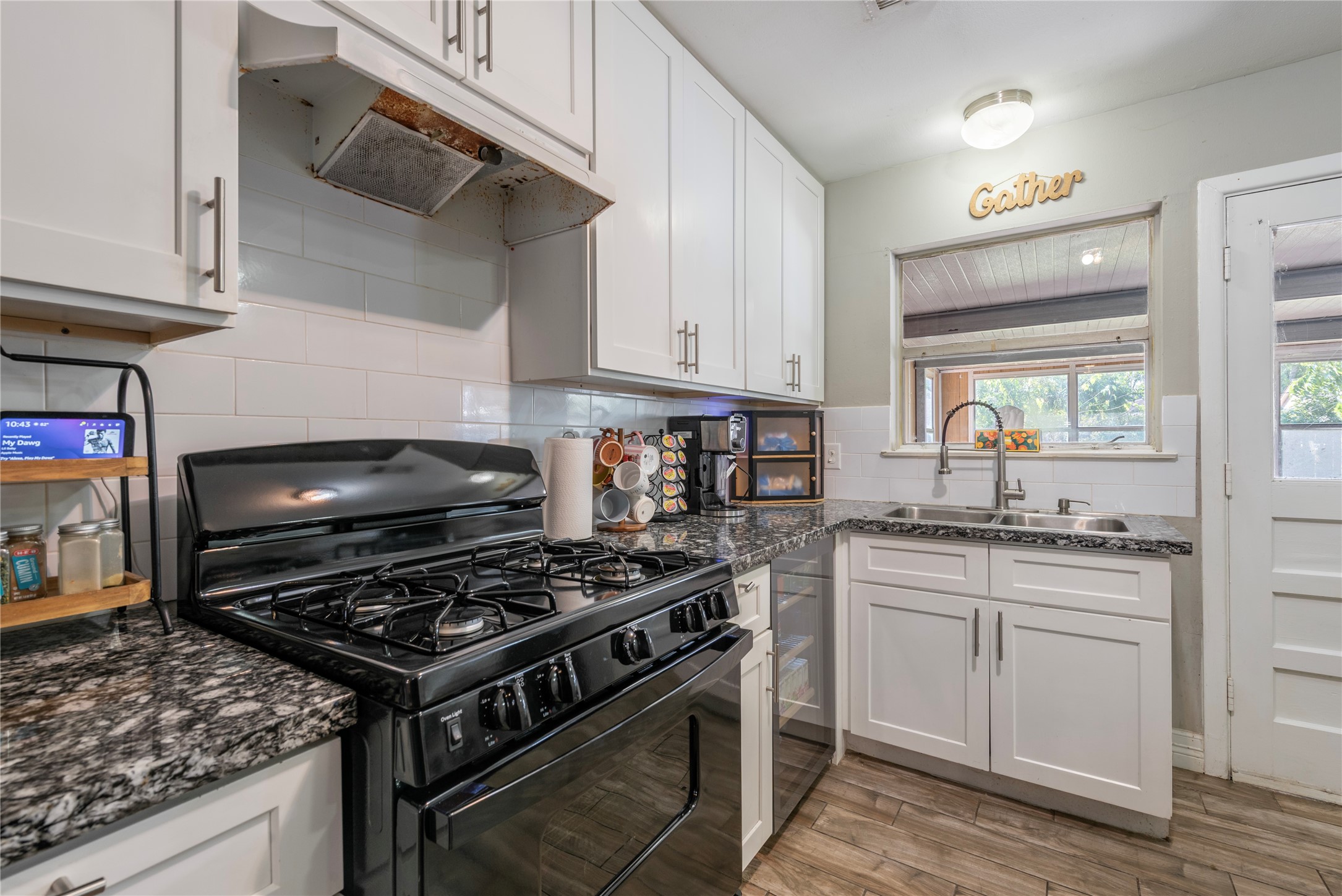 10526 Tolman Street Houston, TX 77034 - Photo 7 of 22 a kitchen with stainless steel appliances granite countertop a sink a stove and a microwave