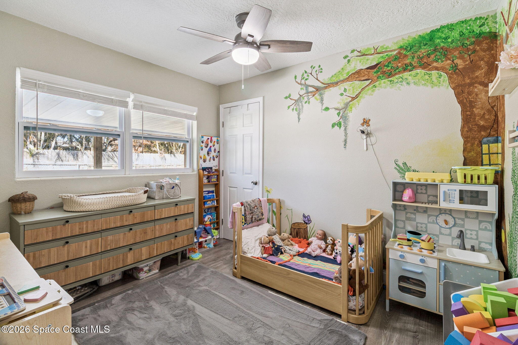 207 2nd Street Merritt Island, FL 32953 - Photo 12 of 19 a room with baby crib and a window
