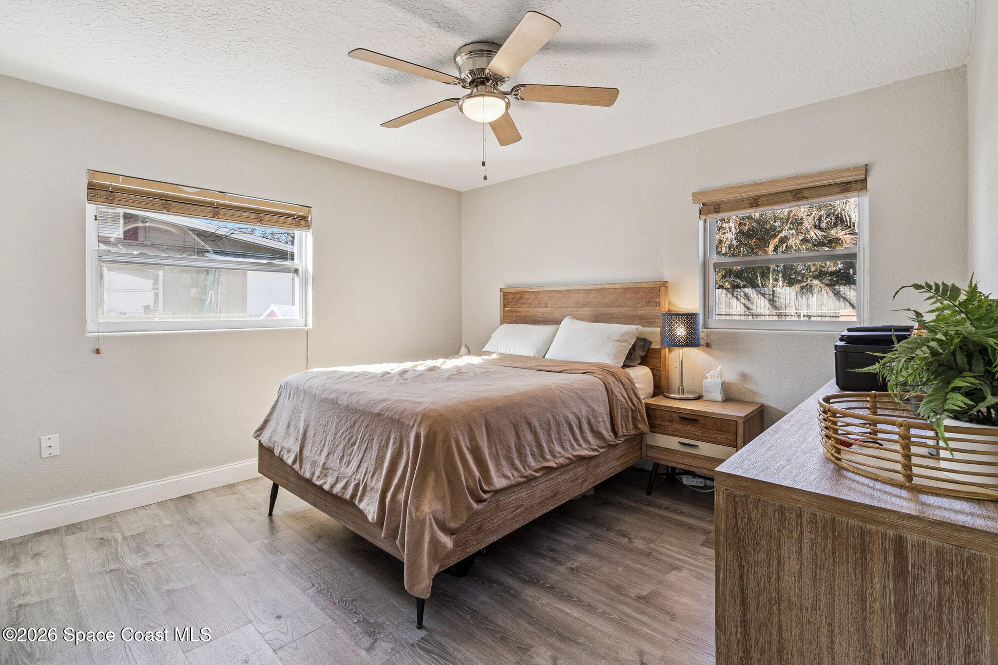 207 2nd Street Merritt Island, FL 32953 - Photo 13 of 19 a bedroom with a bed and wooden floor