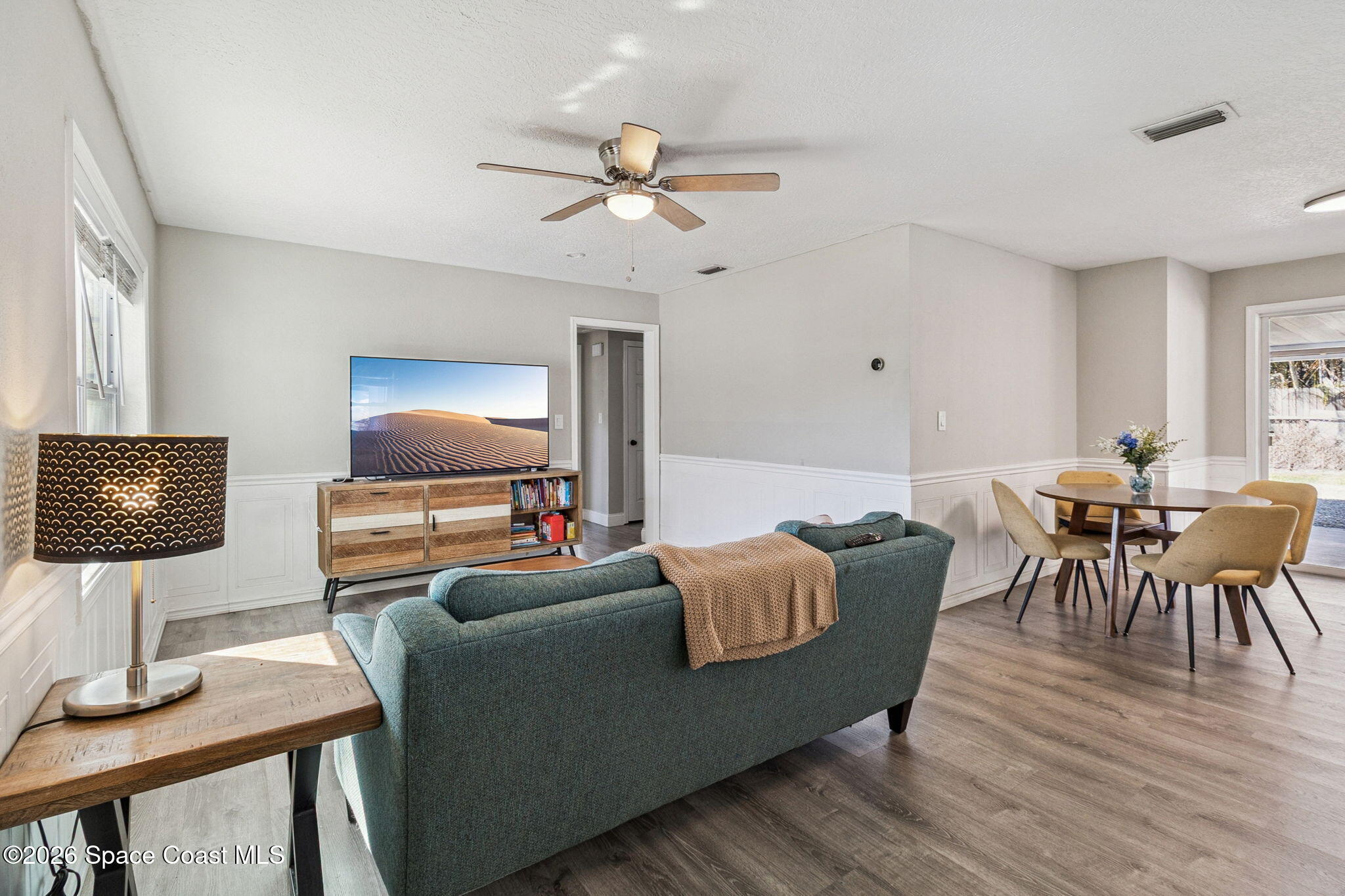 207 2nd Street Merritt Island, FL 32953 - Photo 4 of 19 a living room with furniture and a flat screen tv