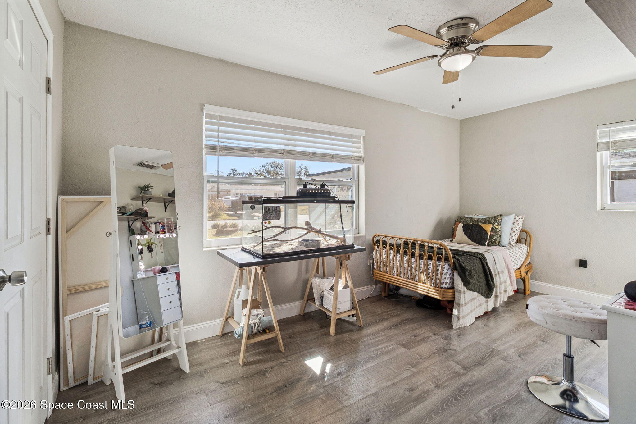 207 2nd Street Merritt Island, FL 32953 - Photo 9 of 19 a bedroom with furniture and a window
