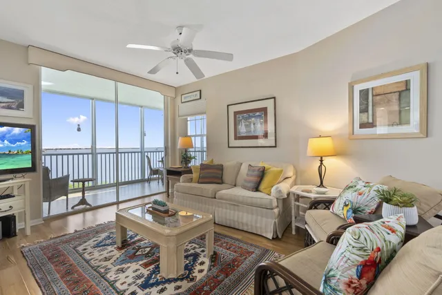 a living room with furniture a flat screen tv and a table